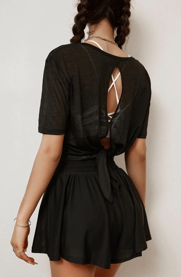 Stylish translucent women's short sleeve top with open back tie-up design in black, perfect for yoga and active wear.